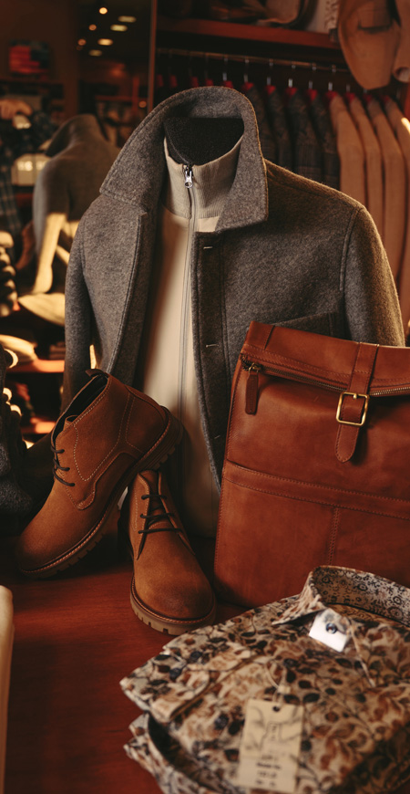 alt="Mens outer wear fashion for fall and winter of 2025. Grey jacket, popped collar and soft leather shoes from Landmark Clothiers"